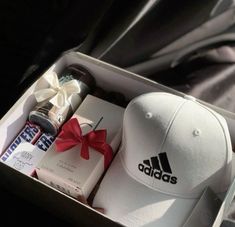 an open box containing a hat and other items