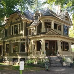 an old victorian style house in the woods