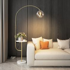 a white couch sitting next to a lamp on top of a wooden wall in a living room