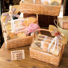 three baskets filled with pastries sitting on top of a wooden table