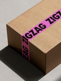 a cardboard box with pink tape on the side and black lettering that reads glac tgt