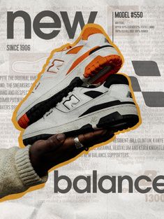 a hand holding a new balance shoe in front of a newspaper advertisement for the company