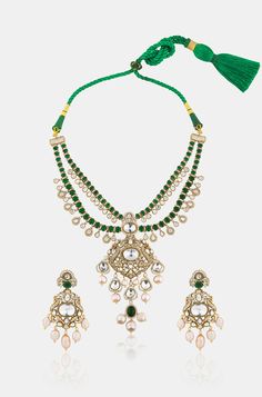 Unveil timeless elegance with this Layered Green Pendant Necklace Set, crafted with precision and style. The set is made from durable brass with a lustrous yellow gold finish, featuring a cascade of layers that exude sophistication. At its heart is a striking green emerald pendant, framed by sparkling Polki stones for an added touch of glamour. Delicate pearls are interspersed throughout, lending a classic, refined feel to the design. The vibrant green hues are balanced by the warm gold and the Elegant Gold Kundan Jewelry, Elegant Gold Kundan Necklace Made Of Brass, Elegant Gold Kundan Necklace In Brass, Opulent Gold Jewelry With Elegant Design, Exquisite Gold Necklaces With Jewels, Elegant Brass Jewelry Sets For Celebration, Festive Formal Brass Necklace, Formal Festive Brass Necklace, Opulent Gold Necklace For Gift