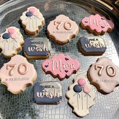 some cookies that are on top of a pan with icing and fondant decorations