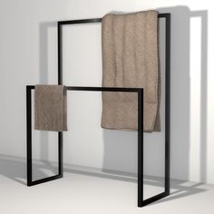 a towel rack with two towels hanging on it's sides and one folded up