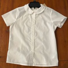 The Top Is New With Tags. I Great School Wear Top Made From Cotton And Polyester, And. Arm Pit To Armpit Is 16 Inches Wide. White Short Sleeve Tops With Buttons, Collared Summer Shirt For School, Collared Shirt For School In Summer, Classic Fitted School T-shirt, White Button-up Plain Top, White Plain Button-up Top, White Short Sleeve T-shirt With Buttons, Classic Fitted Tops For School, Classic Plain Cotton Blouse