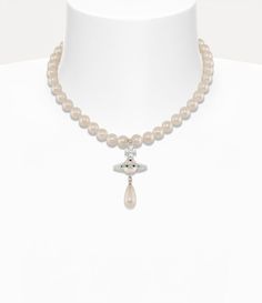 In the late 1980s, Vivienne Westwood unveiled her iconic pearl concept during the Harris Tweed Fall 1987 fashion show, featuring a single-strand choker. Our One Row Pearl Drop choker echoes the elegant form of her original design, showcasing a three-dimensional orb motif adorned with crystal accents and a suspended teardrop, pearl detail. 1987 Fashion, Vivienne Westwood Pearl Necklace, Lux Gifts, Harris Tweed, Watch Gifts, Pearl Drop, Natural Pearls, Lace Boots, Vivienne Westwood