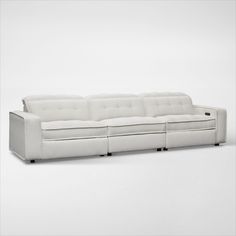 a white couch sitting on top of a white floor