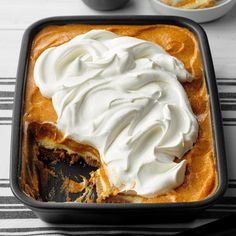 a cake in a pan with whipped cream on top