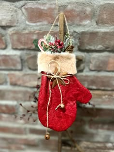 a christmas stocking hanging on a brick wall