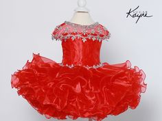 Make a sweet statement in the Sugar Kayne Little Girls Cupcake Pageant Dress! This gorgeous dress brings fun flair with its ruffled organza skirt and beaded mesh neckline. Ruffled organza skirt adds volume and movement Corset tie in back creates a flattering fit Beaded mesh neckline provides delicate shine Perfect for pageants, birthday parties, and any event that calls for a dress with wow factor. The Sugar Kayne Cupcake Dress ensures your princess steals the spotlight! Blush Kids Luxury Coutur Fitted Organza Pageant Dress For Dress-up, Organza Tutu Dress With Ruffles For Dress-up, Fitted Tulle Pageant Dress With Ruffles, Elegant Red Ruffled Pageant Dress, Fitted Ruffles Tutu Dress For Pageant, Organza Pageant Dress With Ruffles For Dress-up, Wedding Pageant Dress With Ruffles And Organza, Spring Princess Dress With Ruffles For Pageants, Red Ruffled Princess Dress For Pageants