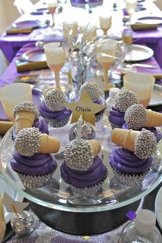 cupcakes with purple frosting and silver decorations