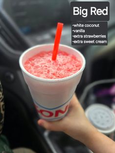 a person holding a drink in their hand with the caption, big red while coconut vanilla extra strawberries extra sweet cream