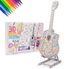 a wooden guitar with colored pencils and coloring book in front of the package on a white background