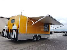 a yellow trailer parked on top of a parking lot