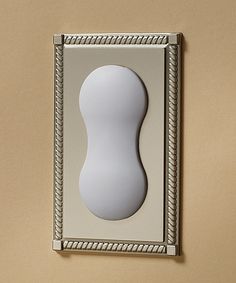 a white object mounted to the side of a wall in a room with beige walls