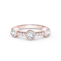 a rose gold ring with three diamonds