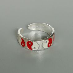 A sterling silver toe ring enameled with a red and white yin yang design. 5mm wide. This is an open ended toe ring and can be adjusted to fit most feet. These toe rings are made of 925 hypoallergenic sterling silver. Please note this price is for ONE toe ring only. Sent in a gift box. I can include a personal message from you if needed You are welcome to contact me at... bhavnakwintra1956@gmail.com For more beautiful pieces from my shop, please browse 👇 TOE RINGS: https://www.etsy.com/your/shop Adjustable White Toe Rings For Gift, Adjustable White Toe Rings As Gift, White Sterling Silver Toe Rings For Gift, White Sterling Silver Toe Rings As Gift, Sterling Silver White Toe Rings As Gift, Yin Yang Designs, Sterling Silver Toe Rings, Silver Toe Rings, Jewelry Minimalist