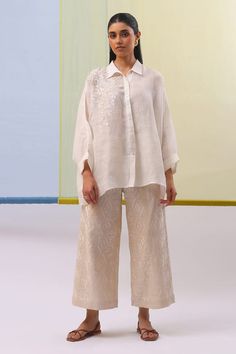 Off white shirt with placed thread embroidered floral motifs. Comes with geometric embroidered pattern pant. - Aza Fashions Elegant Floral Embroidered Palazzo Set, Cotton Long Sleeve Set With Geometric Embroidery, Elegant White Pant Set With Resham Embroidery, Cotton Sets With Geometric Embroidery And Long Sleeves, Summer Resham Embroidery Long Sleeve Pant Set, Elegant Embroidered Summer Pant Set, Cotton Set With Geometric Embroidery And Long Sleeves, Elegant Embroidered Pant Set For Work, Elegant Cotton Pant Set With Floral Embroidery