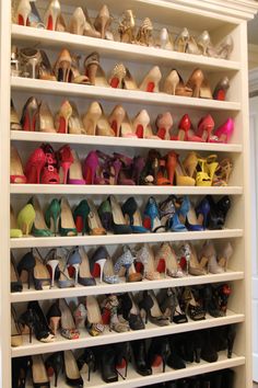 a large white shoe rack filled with lots of different colored shoes on top of it