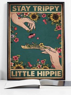 a poster with two hands reaching for flowers in front of an open book that says stay trippy little hippie