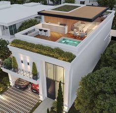 an aerial view of a modern house with pool