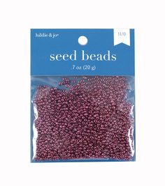 seed beads in plastic bag with white and pink dots on the side, packaging for seed beads