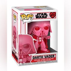 a pink darth vader pop vinyl figure in a white box with red eyes