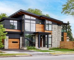 a two story house with lots of windows and wood trimmings on the front