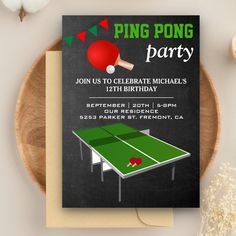 a ping pong birthday party card on top of a table