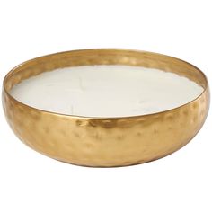 a gold bowl with a white candle inside