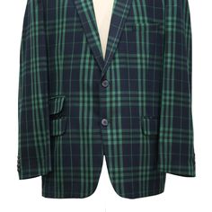 This Chiragh Apparel blazer is an elegant upgrade on dapper tailoring and features rich shades in a sumptuous fabric for elegant opulence. Fashioned from premium quality wool, this plaid check blazer features full lining in Japanese silk, a notch lapel, two-button closure and single-vented back. A left chest pocket and three flap pockets appoint the front while the inside has two (2) pockets on the left and one (1) pocket on the right. A flash of contrast piping is added to the jacket lining ins Tailored Long Sleeve Sport Coat For Semi-formal Occasions, Tailored Long Sleeve Sport Coat For Semi-formal, Elegant Green Sport Coat For Business Casual, Green Tweed Jacket With Notch Lapel For Formal Occasions, Green Single Breasted Tweed Jacket For Formal Occasions, Green Single-breasted Tweed Jacket For Formal Occasions, Formal Green Single-breasted Tweed Jacket, Elegant Tailored Green Sport Coat, Tailored Green Sport Coat For Semi-formal Occasions