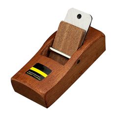 a wooden device holder with a credit card in it and a knife sticking out of the top