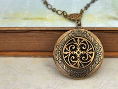 Celtic knot locket in antiqued brass hangs on antiqued brass chain with lobster clasp. No beginning and no ending, the eternity of life. Measurement: Locket is about 1.3 inch (33mm) wide on 18 inch chain. If you have a preferred length for the chain, please let me know in message to seller box and I will adjust it before shipping. Silver plated version listed here, http://www.etsy.com/listing/89558480/the-eternal-knot-celtic-knot-locket?ga_search_query=knot%2Blocket%2B&ga_search_type=user_sh Antique Gold Medallion Locket Necklace With Intricate Design, Nickel-free Brass Medallion Locket Necklace, Antique Gold Brass Locket Necklace For Gift, Antique Gold Brass Locket Necklace, Bronze Round Brass Locket Necklace, Antique Gold Medallion Locket Necklace, Antique Gold Locket Necklace With Intricate Design, Antique Gold Medallion Locket Necklace In Bohemian Style, Antique Gold Locket Necklace With Intricate Design As Gift