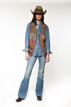 Assemble your outfit and make a statement with this hand-beaded goat suede vest with a little fun fringe for good measure. Throw it on over light chambray workshirt or a crisp white button-down and channel your American spirit! fit: slim suede sleeveless vest, hook and eye closure at center front, patch pocket contrast fringe, heavily beaded, studs 100% goat suede V932 in stock Beaded Studs, Collar Tips, Ranch Wear, Suede Vest, Cashmere Accessories, Blue Vests, American Spirit, Field Jacket, Sleeveless Vest