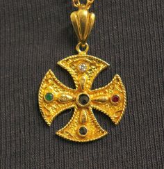 Presented here is an mid 20th Century 14 K Solid Gold Cross Pendant Medal Studded with the 4 precious stones : Diamond, Ruby, Sapphire and Emerald. Gold content has been tested and hallmarks on bail. Excellent Jewelry typical hand work  seldom seen. The medal is in near new condition and it is sold WITHOUT the chain in the picture.  It is a very fine, rare and  extremely nice item to wear.  Dimensions of the medal are : 20 x 20  mm in diameter ( 0.8 in.)  - excluding bail  Weight is 2.7 grams Pictures are an intrinsic part of the description. Please use the zoom feature.  FREE SHIPPING WORLDWIDE  My selling principle is : " SATISFACTION OR REFUND " AND IT APPLIES 100 %.  I am ready to refund in totality any item sold by me if you are not fully satisfied with your purchase. NO QUESTIONS ASK Antique Multi-stone Ceremonial Jewelry, Gold Byzantine Jewelry With Multi-stone, Gold Byzantine Multi-stone Jewelry, Byzantine Multi-stone Jewelry As Gift, Vintage Multi-stone Ceremonial Jewelry, Vintage Multi-stone Jewelry For Ceremonial Occasion, Gold Byzantine Jeweled Jewelry, Byzantine Jeweled Gold Jewelry, Byzantine Style Jeweled Gold Jewelry