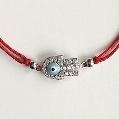 925 sterling silver hamsa evil eye red bracelet .adjustable .for protection ,good luck and prosperty. --comes with free gift pouche. pulsera rojo de plata esterlina 925 mano de fatima ojo de la buena suerte. ajustable. para proteccion ,buena suerte y prosperidad. --gratis bolsa de regalo. Adjustable Sterling Silver Evil Eye Jewelry, Adjustable Silver Evil Eye Bracelet Gift, Sterling Silver Evil Eye Bracelet With Adjustable Chain, Sterling Silver Evil Eye Bracelet For Gift, Silver Evil Eye Bracelet For Gift, Adjustable Sterling Silver Evil Eye Bracelet, Spiritual Style, Adjustable Sterling Silver Evil Eye Bracelet, Adjustable Sterling Silver Evil Eye Bracelet Gift, Spiritual Adjustable Sterling Silver Evil Eye Bracelet