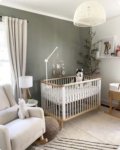 a baby's room with a white crib and rocking chair