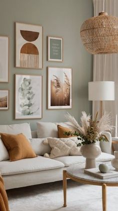 a living room filled with lots of furniture and pictures on the wall above it's coffee table