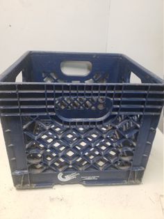 a blue plastic crate sitting on top of a white table