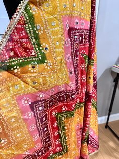 Experience the beauty of traditional Phulkari style with our Multicolor Dupatta. Made with a soft and luxurious silk finish, this dupatta features real mirror accents and stunning designs. Its heavy-weight construction makes it perfect for special occasions like Navaratri. Elevate your wardrobe with this must-have accessory. Approx 2.5 meters length Multicolor Anarkali Set With Mirror Work For Festive Season, Bollywood Style Multicolor Choli With Dupatta, Multicolor Mirror Work Anarkali Set In Art Silk, Multicolor Art Silk Choli With Mirror Work, Multicolor Bohemian Sharara With Bandhani Print, Bohemian Multicolor Sharara With Bandhani Print, Bohemian Multicolor Bandhani Print Sharara, Multicolor Dola Silk Anarkali Set For Traditional Ceremonies, Multicolor Choli With Dupatta For Diwali