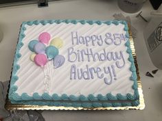 a birthday cake with balloons on it that says happy 85th birthday audrey