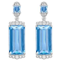 This collection features an array of Aquamarines with an icy blue hue that is as cool as it gets! Accented with Diamonds these Drop Earrings are made in White Gold and present a classic yet elegant look. Aquamarine Drop Earring in 18Karat White Gold with White Diamond. Aquamarine: 14.03 carat, 16.8X9.1X5.9mm size, octagon shape. Aquamarine: 0.57 carat, 4X4mm size, square shape. White Diamond: 0.13 carat, 2.00mm size, round shape, G color, VS clarity. White Diamond: 0.11 carat, 1.50mm size, round