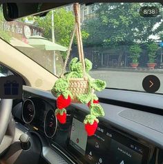 a stuffed animal hanging from the dashboard of a car