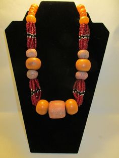 *Special Price* Antique Healing Stones, Sacred Amber, and Juju Beaded necklace.  A sacred necklace for that very special person. This antique necklace was created over 30 years ago by the renowned artist Ife East.  One of a Kind! 14 Amber beads 7 Rare Earth Stones Juju Beads Artisan Single Strand Orange Beaded Necklace, Spiritual Jewelry With Polished Oval Beads, Artisan Necklace For Ceremonial Occasions, Necklaces With Large Beads As Festival Gifts, Traditional Hand-strung Necklaces As Gifts, Unique Orange Necklace With Polished Beads, Artisan Necklace For Ceremonial Festivals, Large Beads Jewelry For Festivals And Gifts, Orange Beaded Amulet Jewelry