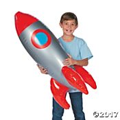 a young boy is holding an inflatable rocket