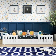 a baby's room with blue and white wallpaper