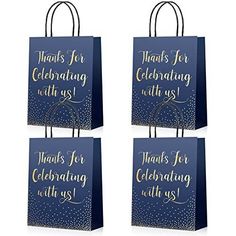 three blue shopping bags with gold lettering on the front and bottom, one is for celebrating with us