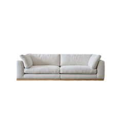 a white couch sitting on top of a wooden table