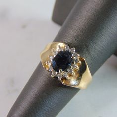 For Sale Is This Lovely Vintage 14k Yellow Gold Diamond & Sapphire Ring With A Total Of About .14cts Of Diamonds. The Total Weight Is 3.7g, And Is A Size 6.0. Any Questions Please Dont Hesitate To Ask. Be Sure To Check Out Some Of Our Other Great Items Up For Sale. Thank You. Classic Sapphire Ring Stamped 14k, Anniversary Cluster Sapphire Ring In Fine Jewelry Style, Fine Jewelry Sapphire Cluster Ring For Anniversary, Formal Sapphire Cluster Ring With Diamond Cut, Anniversary Cluster Sapphire Ring, Anniversary Sapphire Cluster Ring, Oval Sapphire Ring Stamped 14k For Formal Occasions, Formal Oval Sapphire Ring Stamped 14k, 14k Gold Sapphire Cluster Ring With Brilliant Cut